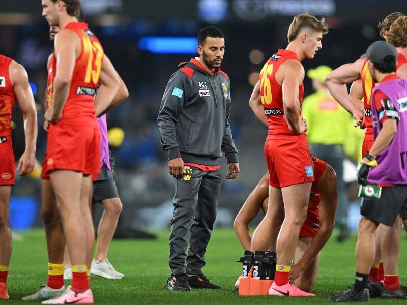 Gold Coast could be without injured co-captain Touk Miller (centre) for up to six games. (James Ross/AAP PHOTOS)